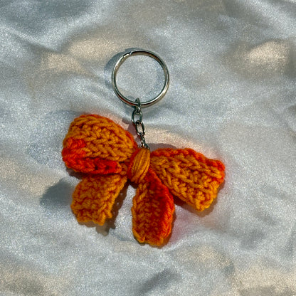 bow keychain on a silver satin background