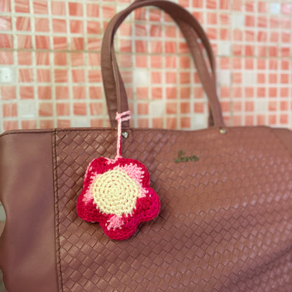 A crochet flower pouch attached to a bag