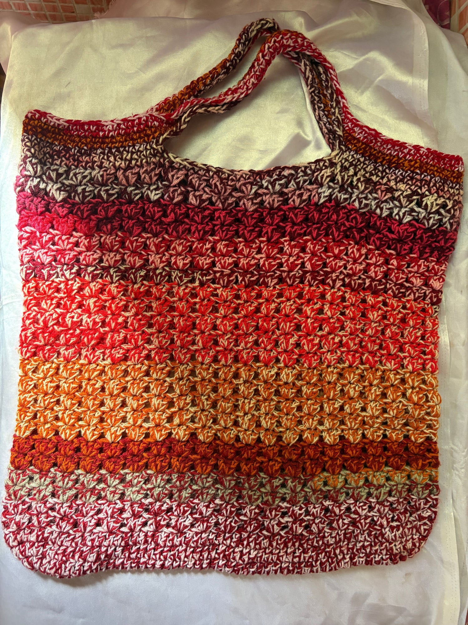 Multicolored crocheted bag on a white background