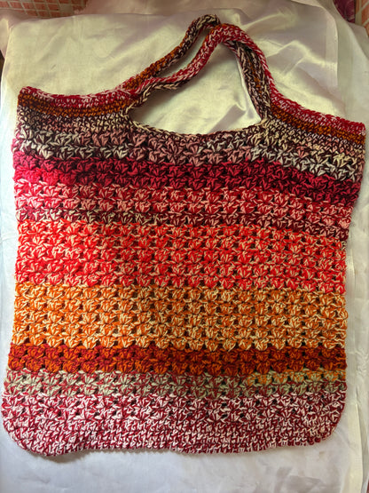 Multicolored crocheted bag on a white background