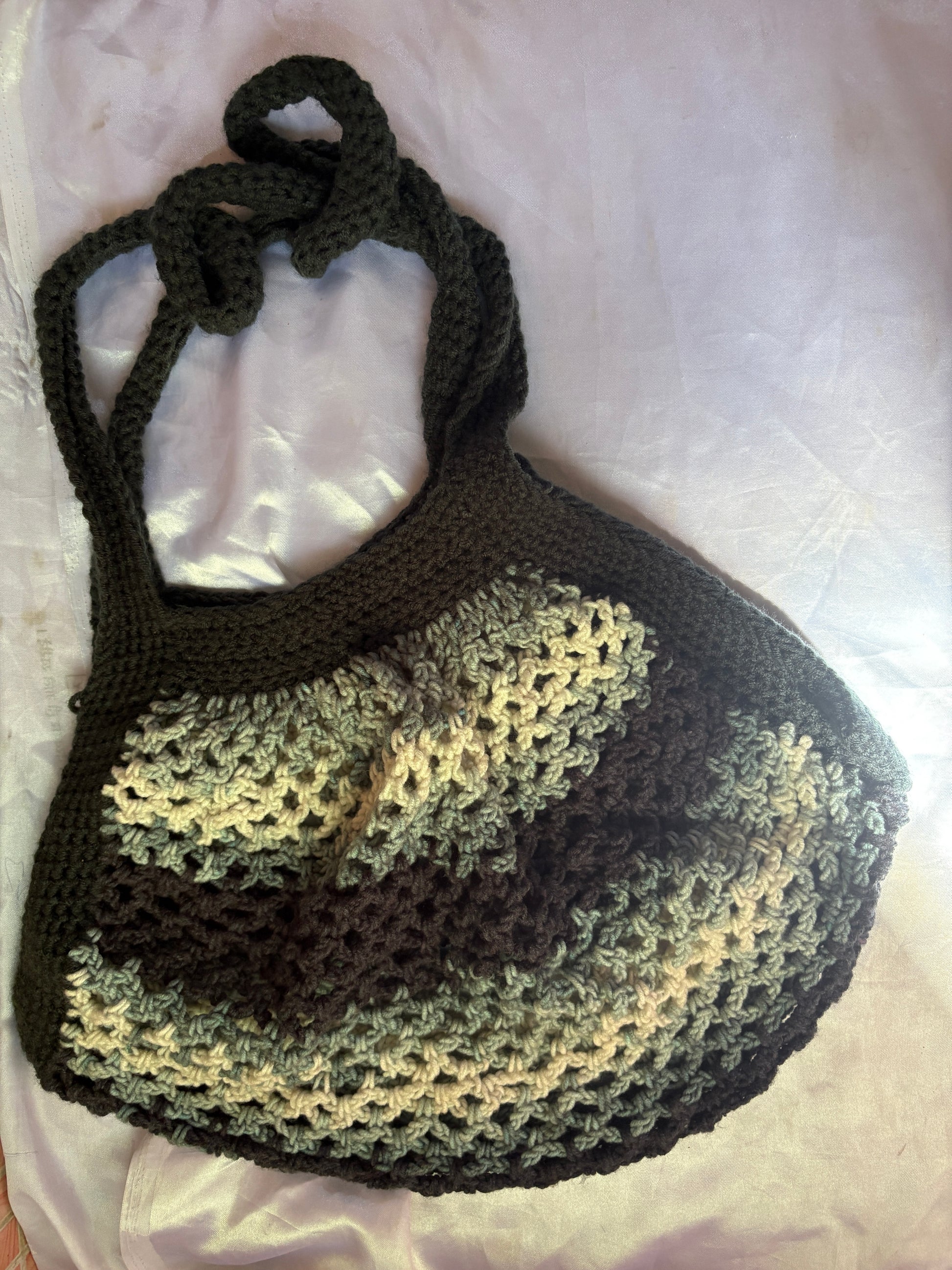 Crocheted bag with a gradient pattern on a white background
