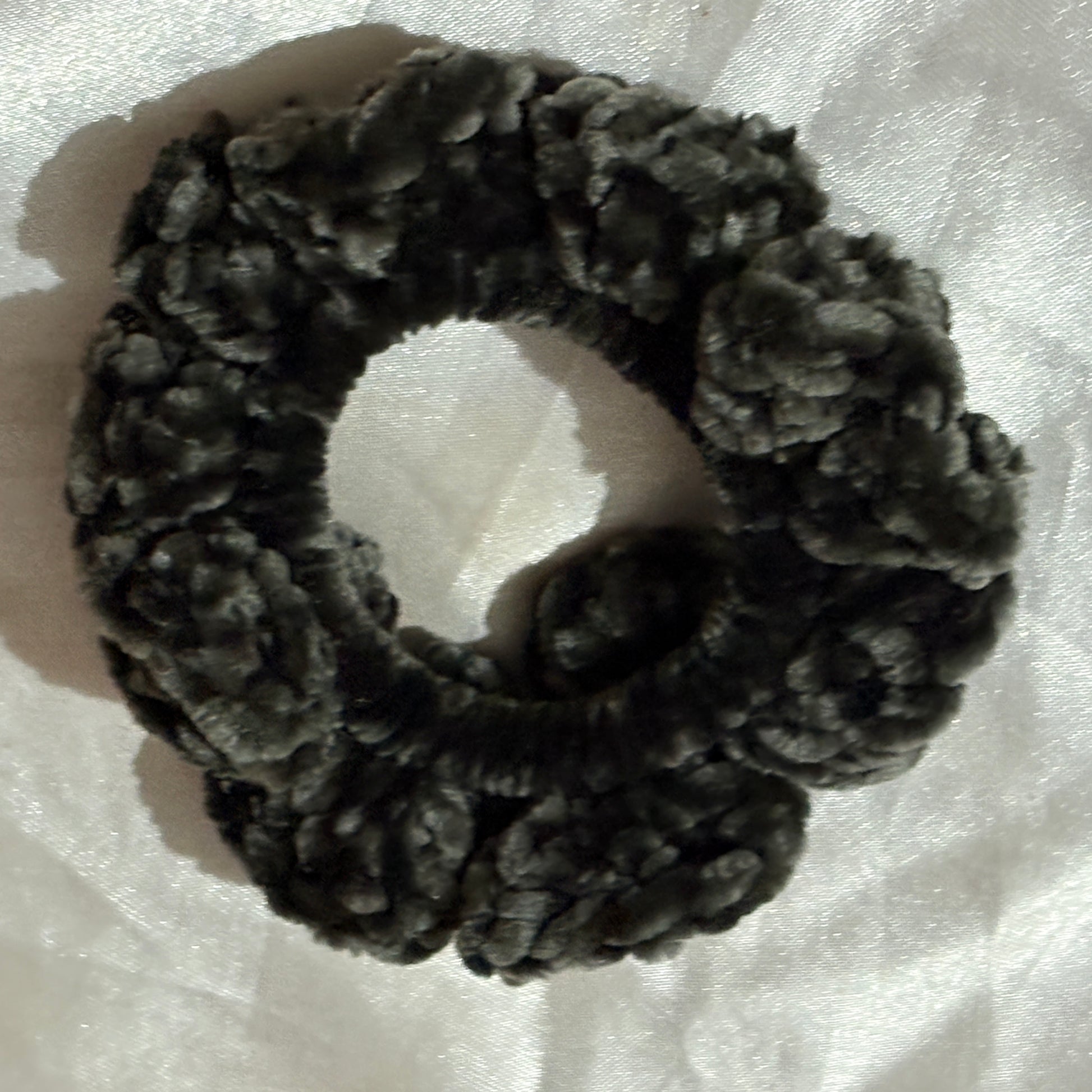Dark gray textured scrunchie on a white background