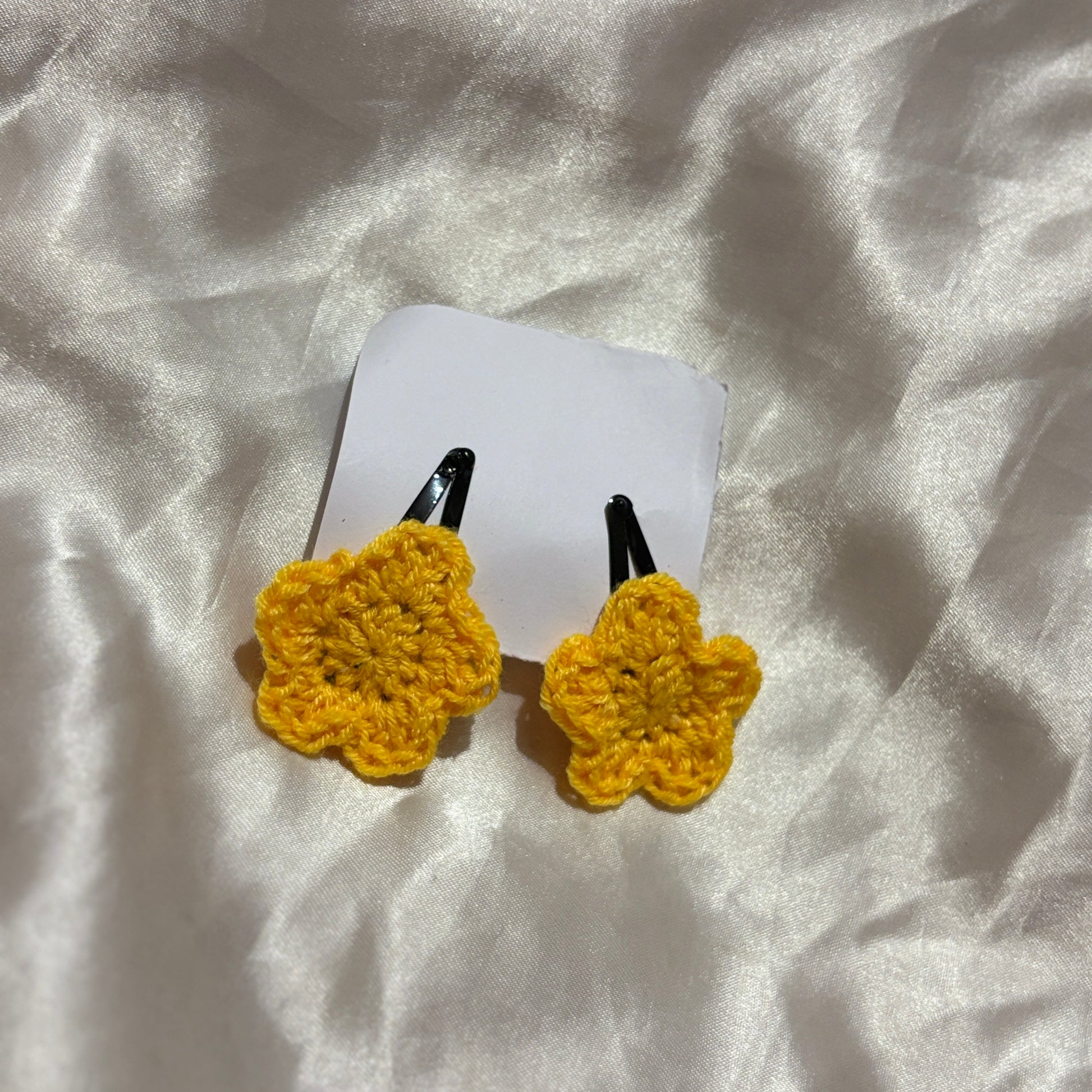 Yellow star-shaped hair clips on a white background