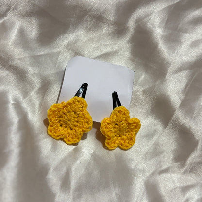 Yellow star-shaped hair clips on a white background