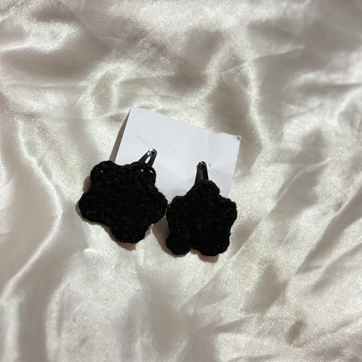 Black star clips on a white fabric background