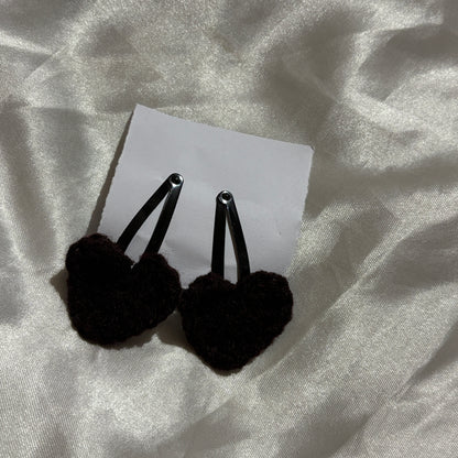 Black clips on a white card with a textured gray background