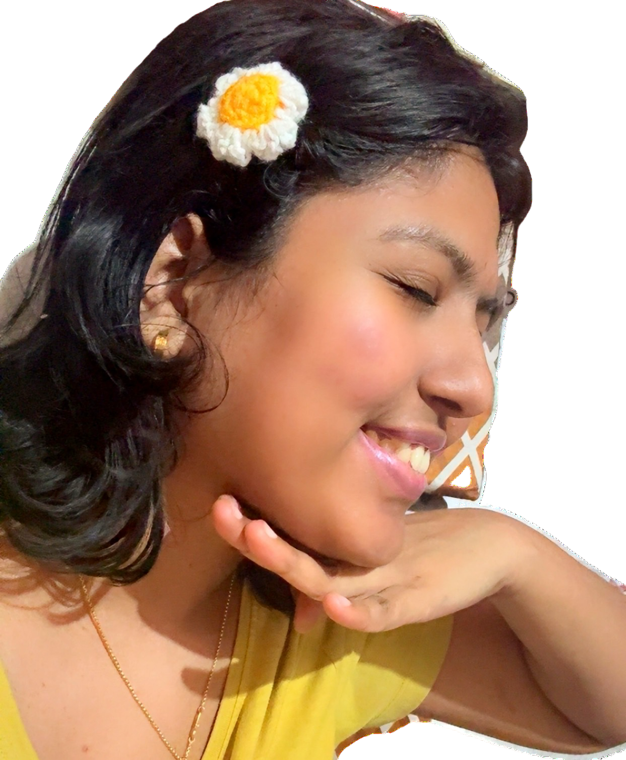 Woman with a flower clip in her hair smiling on a white background