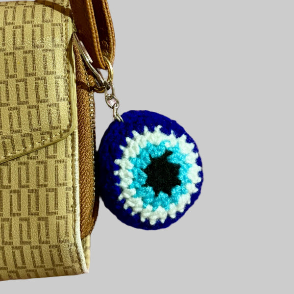 evil eye keychain attached to a bag